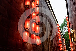 Red lanterns lit outside building in alley