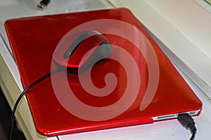 Red laptop with red mouse