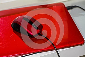 Red laptop with red mouse