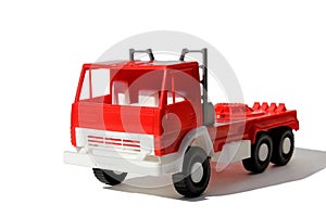 Red large cargo toy car stands on a white background