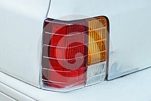 red large glass taillight on a white metal car