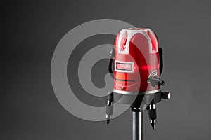 Red laser level tool on grey background