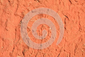 Red laterite stone surface texture background.