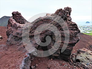 Red lava stones on the top of the volcanoe Eldfell on one of the Westmansislands, Iceland