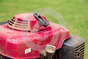 Red lawn mower on golf course.