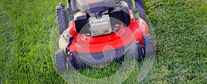 Red Lawn Mower in Lush Green Grass Mowing Lawn