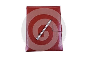 Red leather diary and ball pen isolated on white