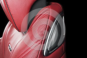 Red leather interior of the luxury modern car. Perforated Leather comfortable seats with stitching isolated on black background. M