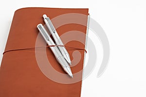 Red Leather Journal Cover With Two Ballpoint Pens