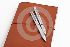 Red Leather Journal Cover With Two Ballpoint Pens