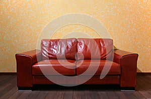 Red leather sofa in room