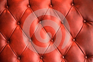 Red leather sofa texture background.