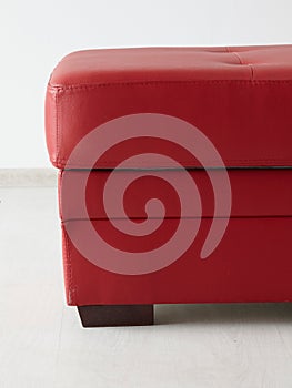 Red leather stool  isolated against the wall