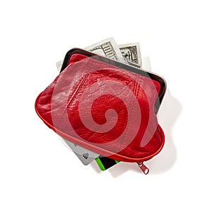 In a red leather wallet are dollar bills, bank credit and debit cards.