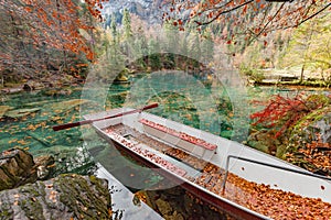 Red leaves and red boat at Blausee/ Blue Lake nature park, Kande