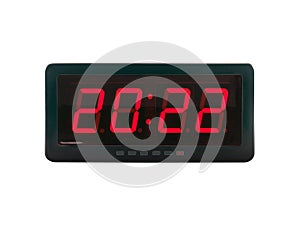 Red led light numbers 2022 illuminated on black digital electric alarm clock display isolated on white background
