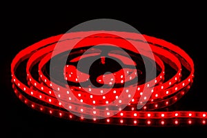 Red LED strip on reel with black background