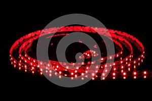 Red LED strip on reel with black background