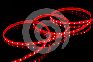 Red LED strip tape on black background