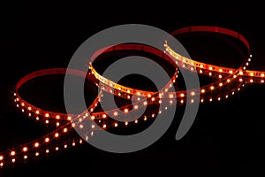 Red LED strip tape on black background