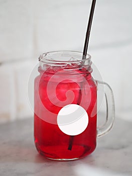 Red lemon soda water flavoured drink, Cool Drinks Beverages with ice in clear glass on white table
