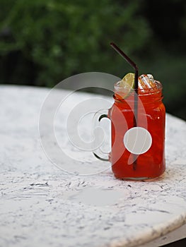 Red lemon soda water flavoured drink, Cool Drinks Beverages with ice in clear glass on white table