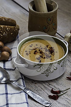 Red lentil soup with vegetables on the wooden background