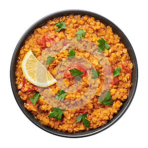 Red lentils dal in black bowl isolated on white. Indian cuisine dish. Indian food. Asian vegetarian meal