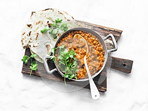 Red lentils dhal and paratha flatbread - healthy vegetarian dinner in Indian style on light background