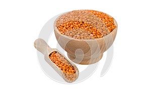 Red lentils in wooden bowl and scoop isolated on white background. nutrition. bio. natural food ingredient