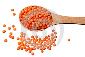 red lentils in wooden spoon isolated on white background. Top view