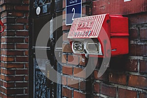 Vintage Red Mailbox on the old brick wall
