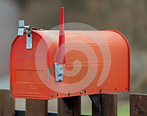 Red letterbox with the raised rod to signal the presence of mail