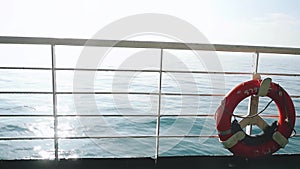 Red life buoy over blue calm sea water background. Real time in slow motion. 1920x1080