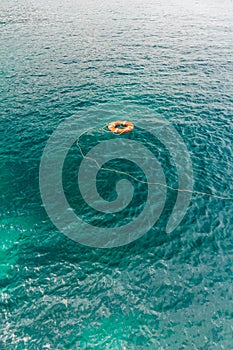 Red life buoy in the water
