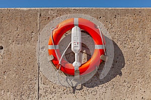 Red life safety ring buoy at port harbor prevent drowning in sea cannot swim