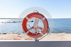 Red life safety ring buoy at port harbor prevent drowning in sea cannot swim