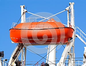 Red lifeboat on crane lift photo