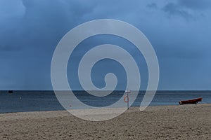 Red lifebuoy on a background of empty sand beach