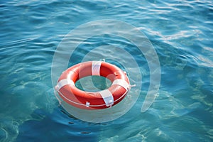 Red lifebuoy on blue water