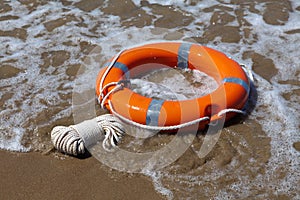 Red lifebuoy in foamy waves