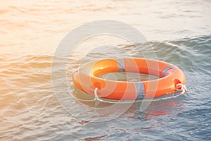 Red lifebuoy pool ring float. Life ring on the sea sand