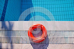 Red lifebuoy pool ring at swimming pool. Red pool ring in cool b