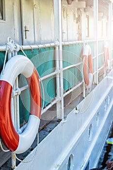 Red lifebuoy with rope on weathered boat