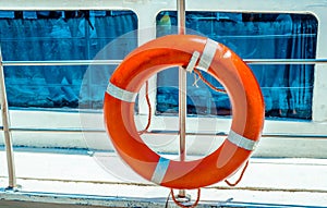 Red lifebuoy on ship railing