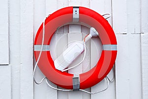 Red lifebuoy.White background of the wall.