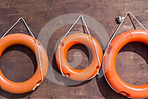 Red lifebuoys on a wooden board closeup