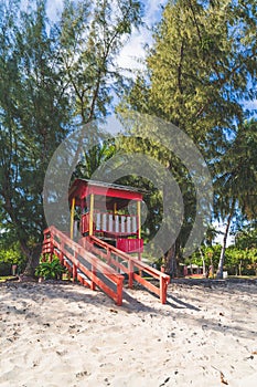 Red Lifeguard hut along shore of Seven Sea beach in tropical Fajardo Puerto Rico