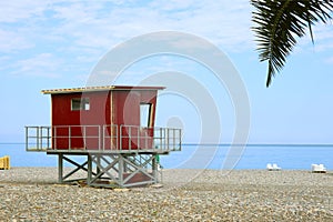 Red lifeguard hut on the empty beach