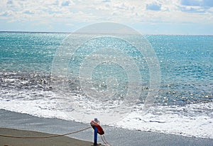 Red lifesaver on the beach - rescue concept